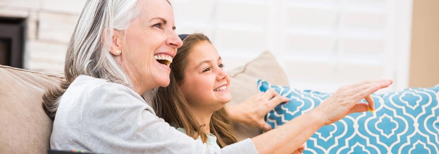 A mother watching TV with her daughter