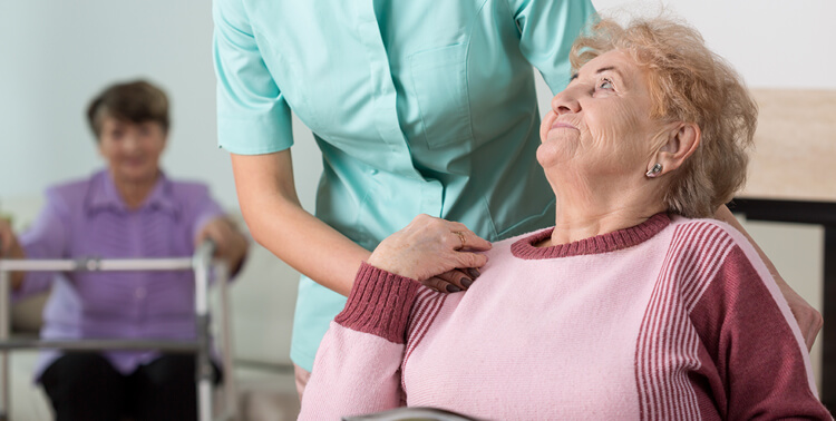 a young caring therapist nursing a senior woman