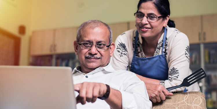 a senior indian asian couple doing some home accounting