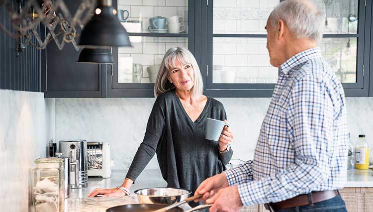 mature couple chatting in the kitchen