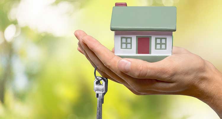 hand holding house key ring and keys
