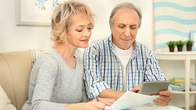mature couple looking over their paperwork