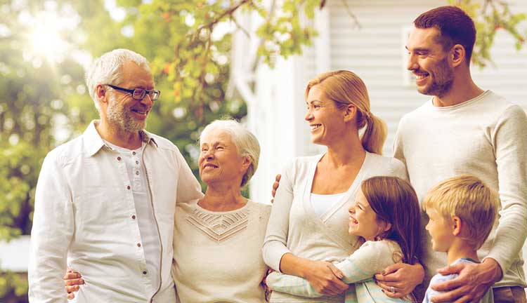 extended family hugging and smiling at each other