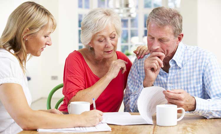 a couple sitting at a table with an expert adviser