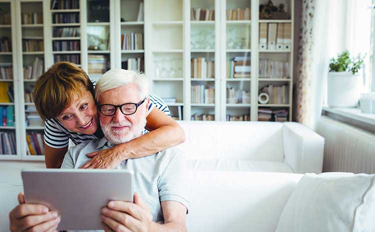 happy couple looking at a laptop together