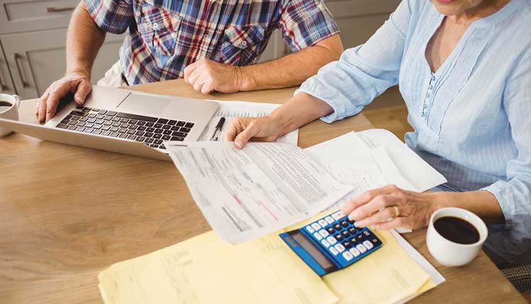a mature couple looking through their finances