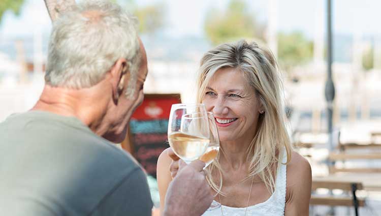 happy couple clinking glasses of wine