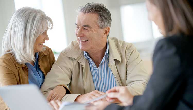 happy couple talking with an adviser