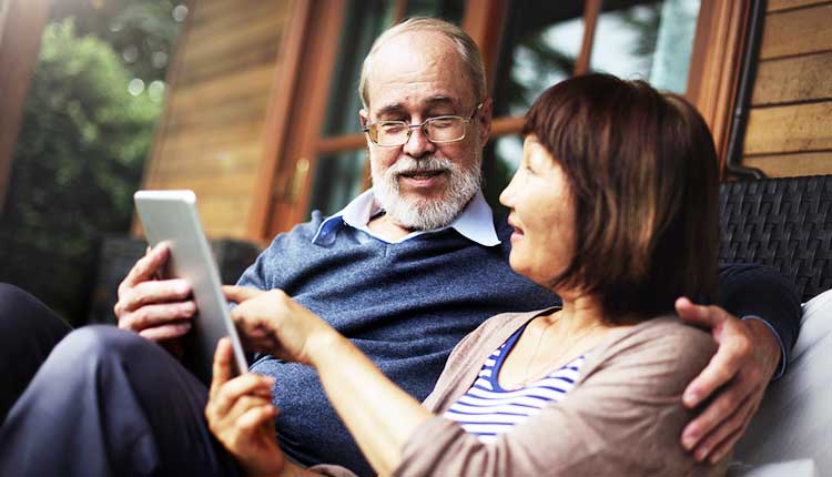 couple on vacation looking at a mobile phone