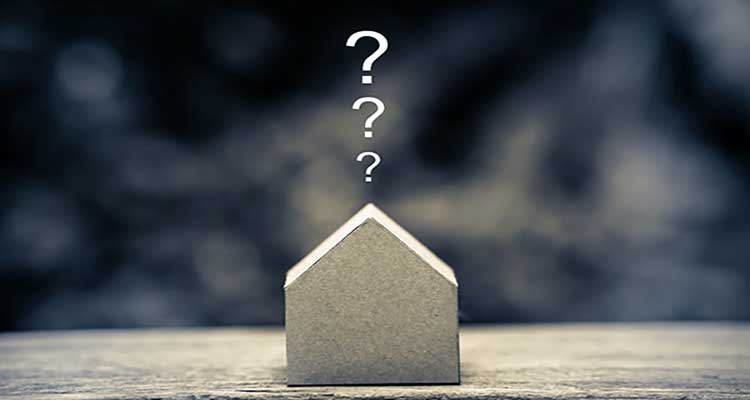 model paper house with question marks above