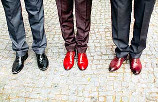A line of 3 mens legs in suits with polished shoes