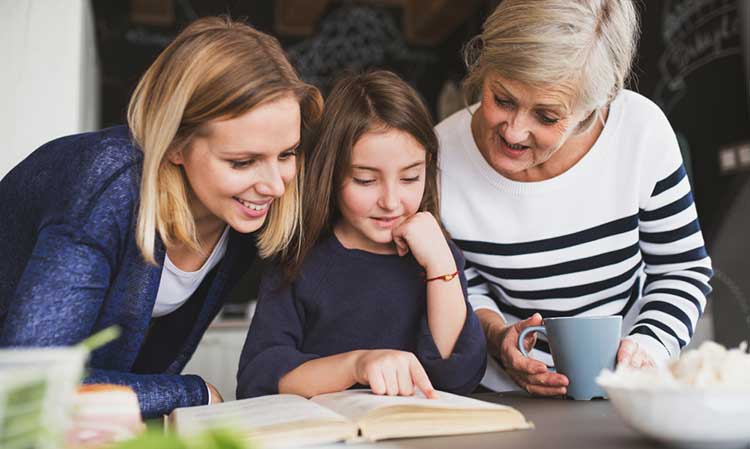 three generations of a family reading a book
