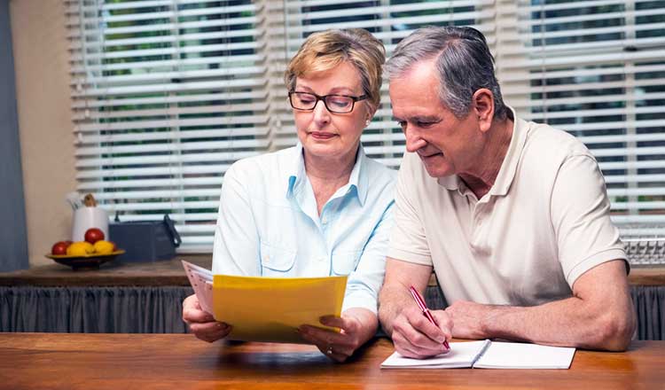 over 60s couple reviewing their finances