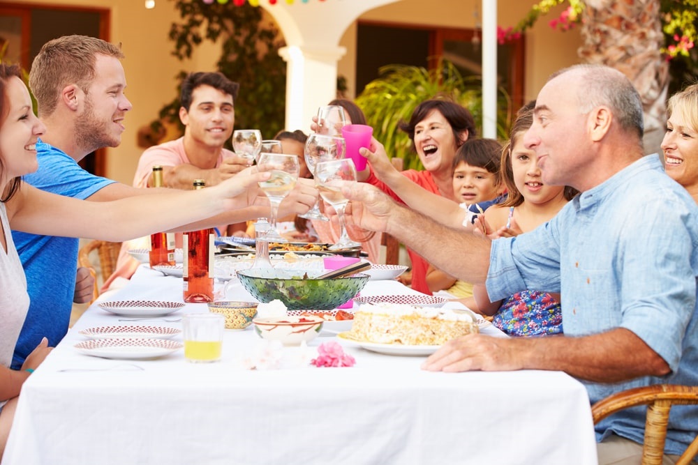 A family toasting at the dinner table