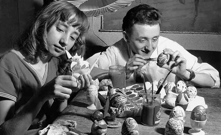 girl and boy painting eggs