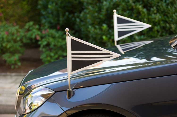 funeral car with flags on each side