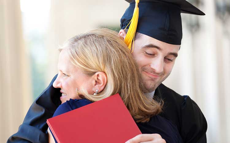 son hugging his mother on graduation day