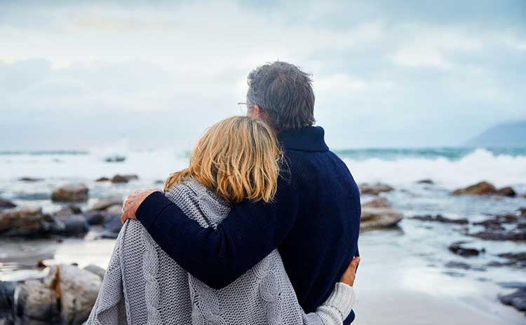 husband and wife looking out to sea