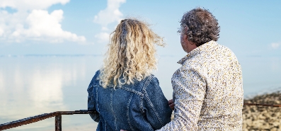 Man and woman looking out into ocean