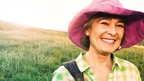 Lady smiling wearing pink hat outdoors