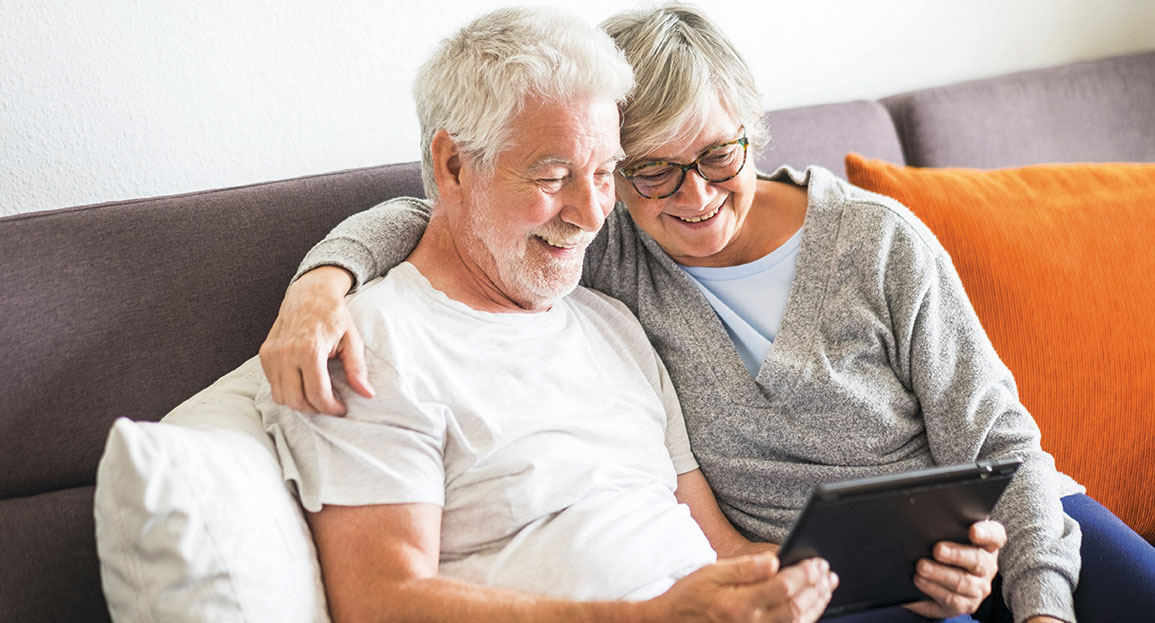 older couple looking at ipad.