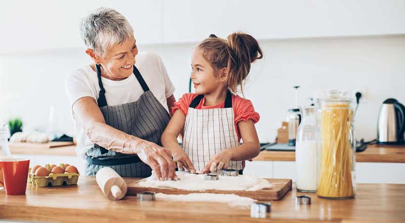 Grandma and grandchild baking in the kitchen