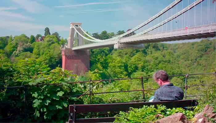 chris writing near the clifton suspension bridge bristol