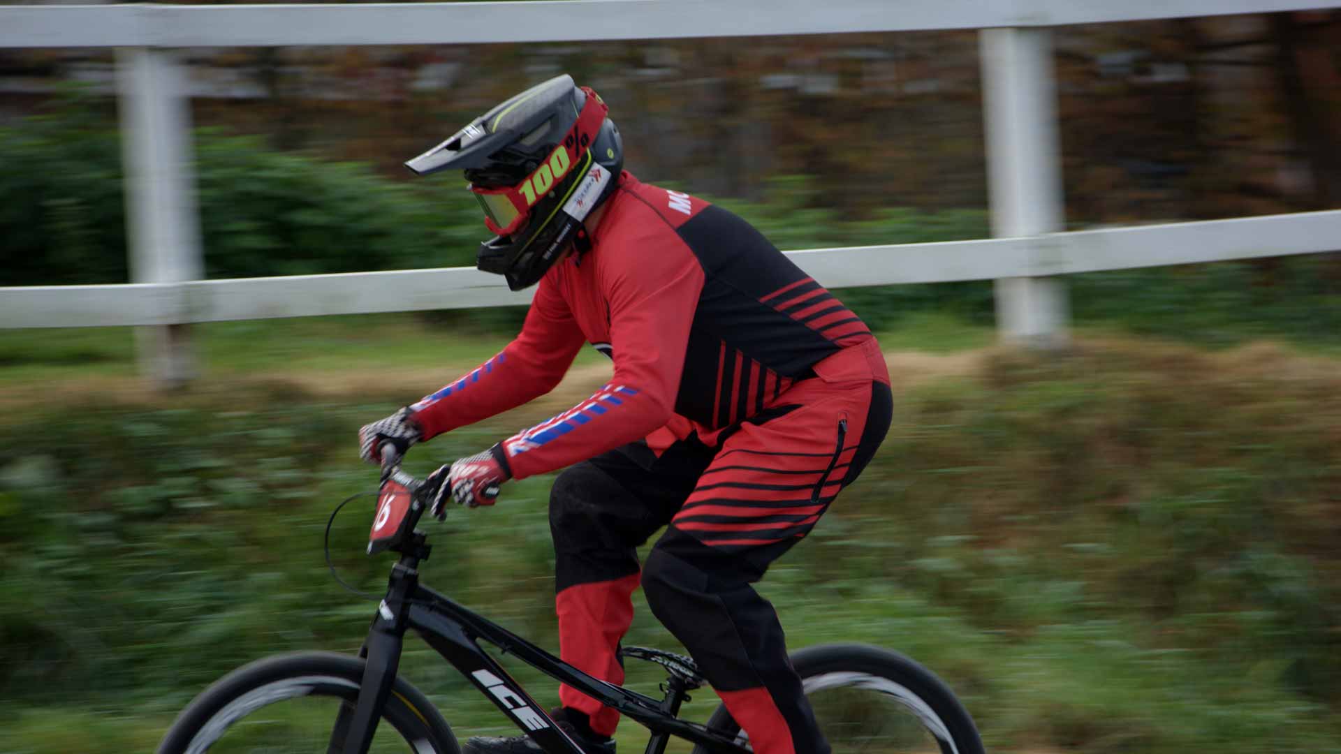 Paul Mounsey riding his BMX round a race track.