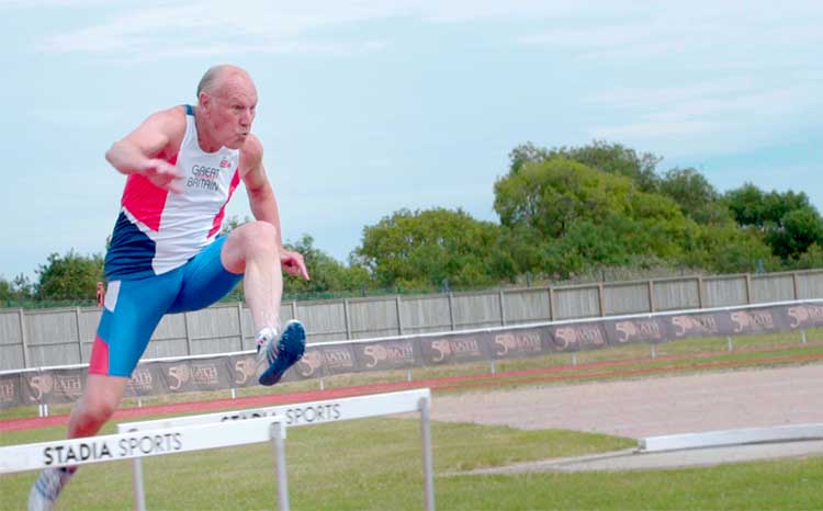 tony jumping over a hurdle